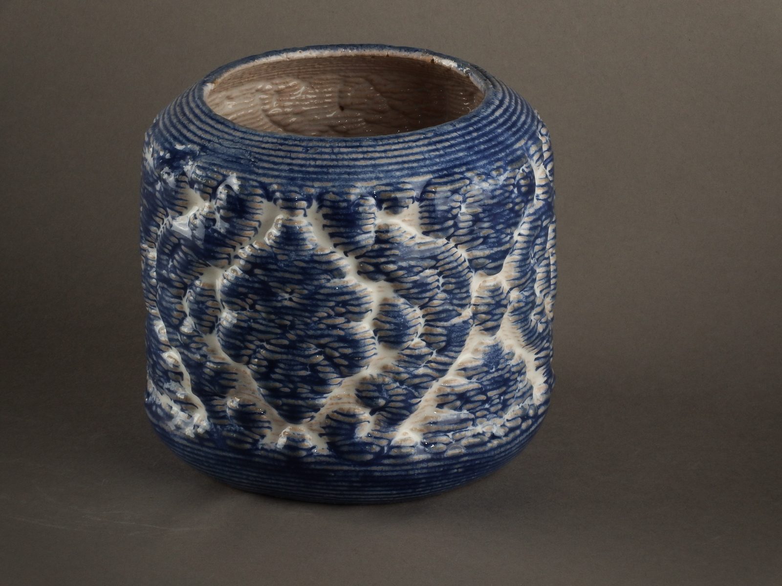 Printed vessel with a raised blue and white ceramic pattern
