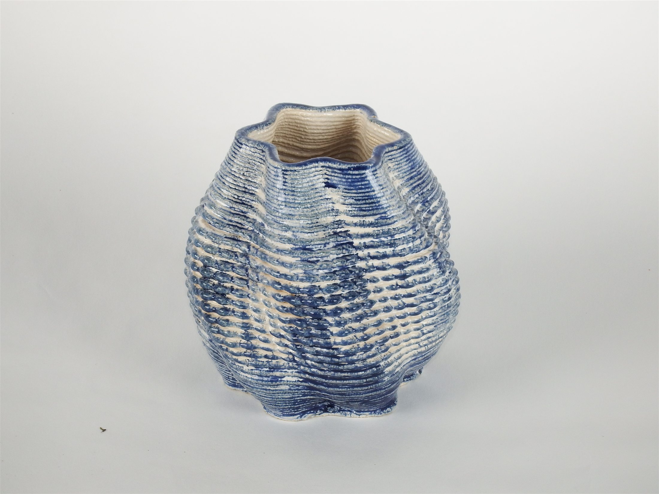 Star-shaped ceramic vase with a layered blue and white glaze